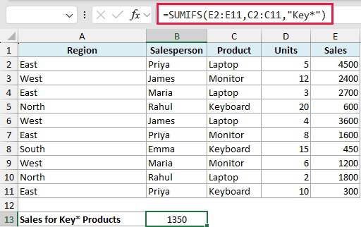Excel formula bar showing SUMIFS with a wildcard asterisk to sum sales for products starting with Key